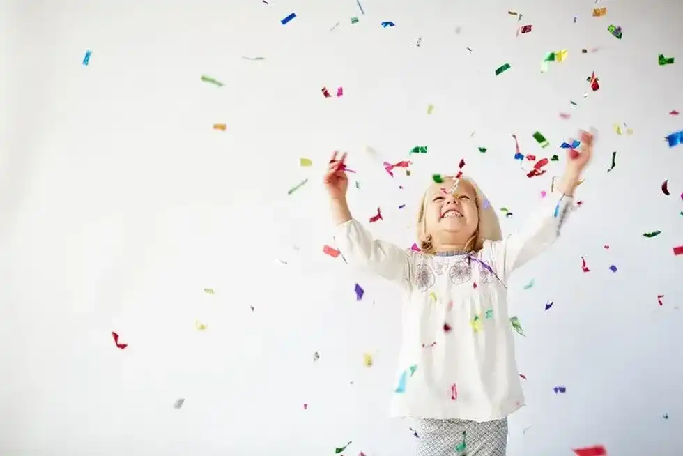 Child playing with confetti