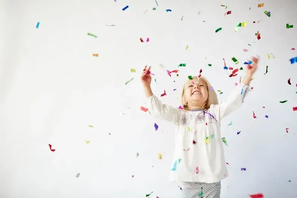 Child playing with confetti