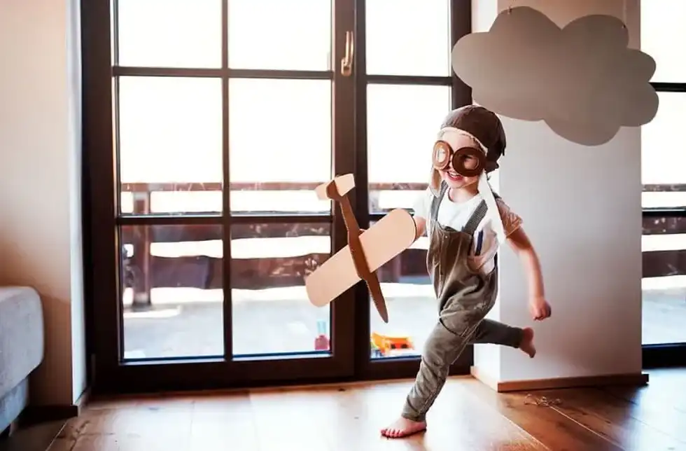 Child plays with airplane to demonstrate their airplane jokes
