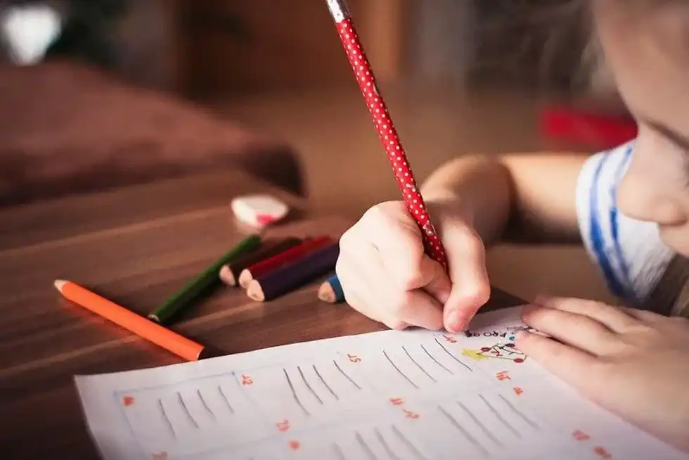 Child practising their handwriting.