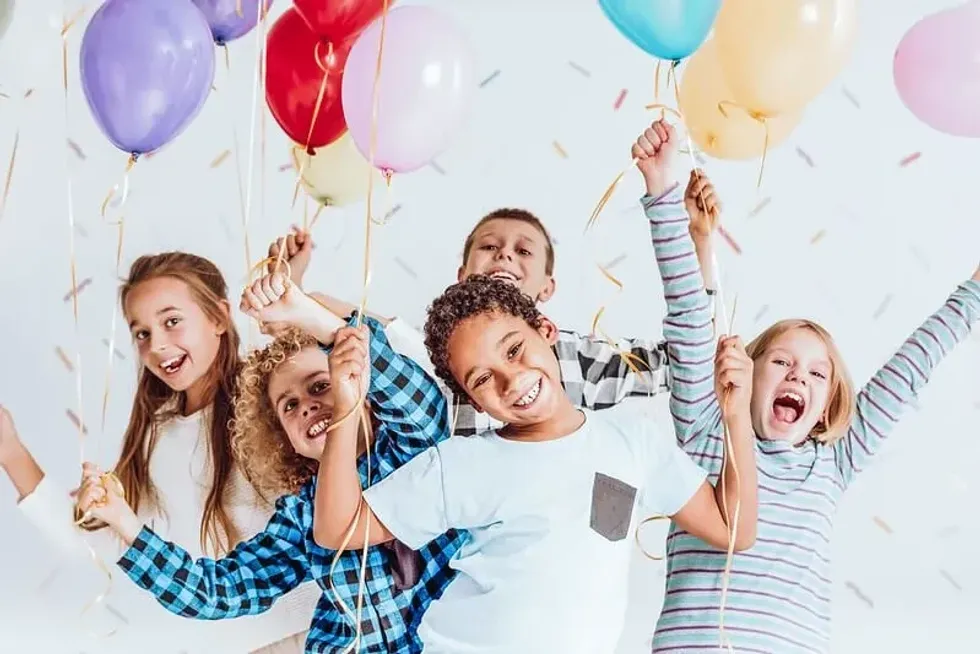 Children at a birthday party ready to dance to the ultimate kids party playlist to groove to
