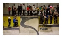 Children in protective gear waiting at the top of a ramp at LS-TEN Skatepark.
