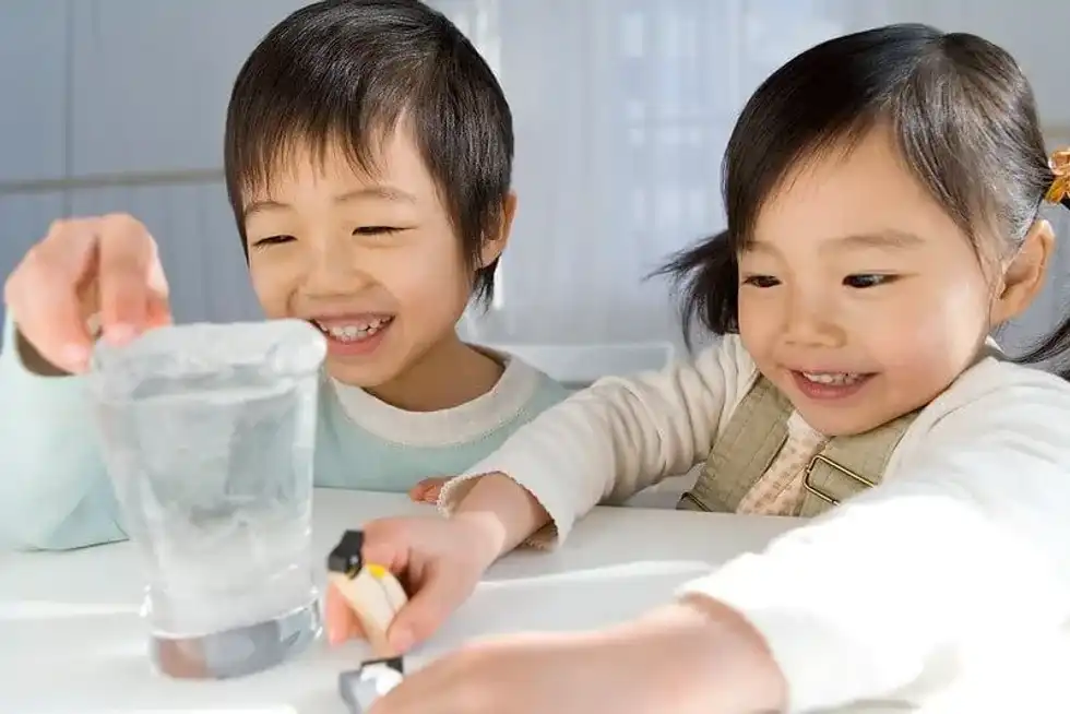 Children making a floating paperclip