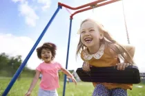 Children playing on a swing