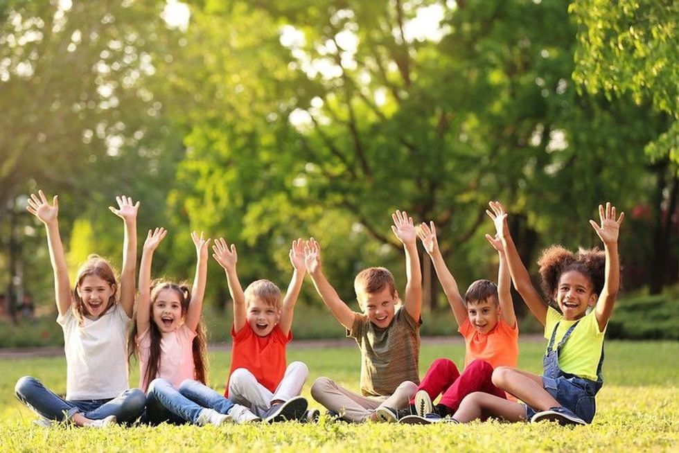 Children sitting on grass