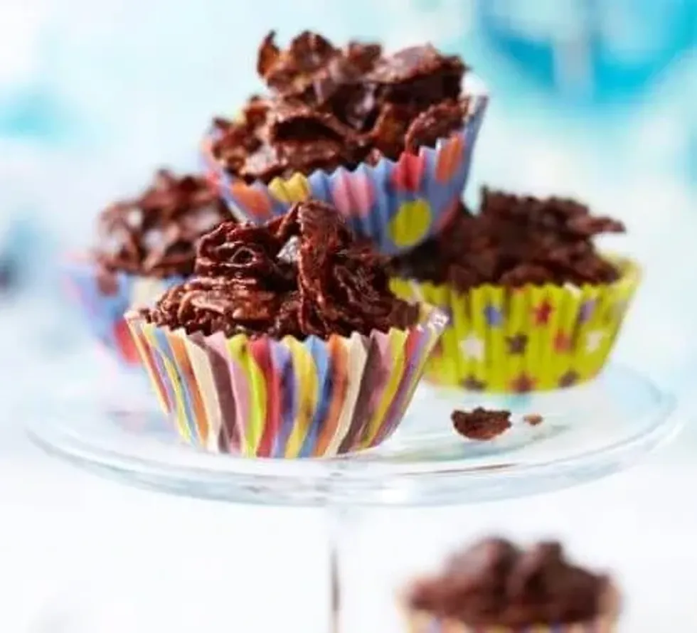 Chocolate cornflake cakes stacked on a cake stand.