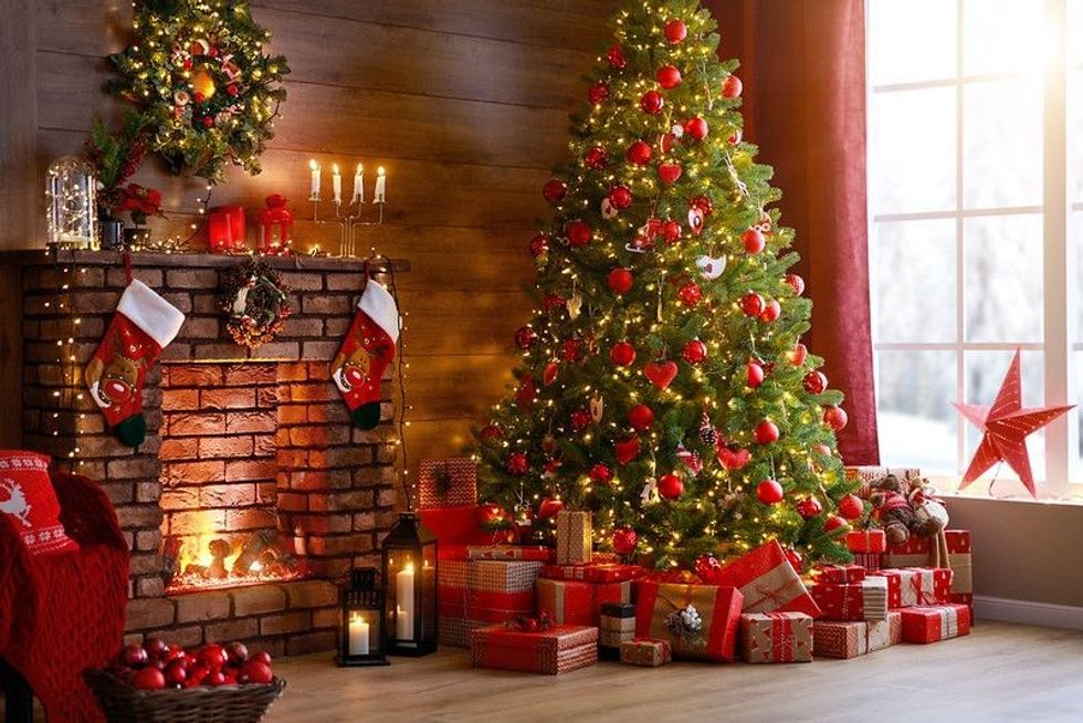 Christmas tree decorated with gifts in house interior