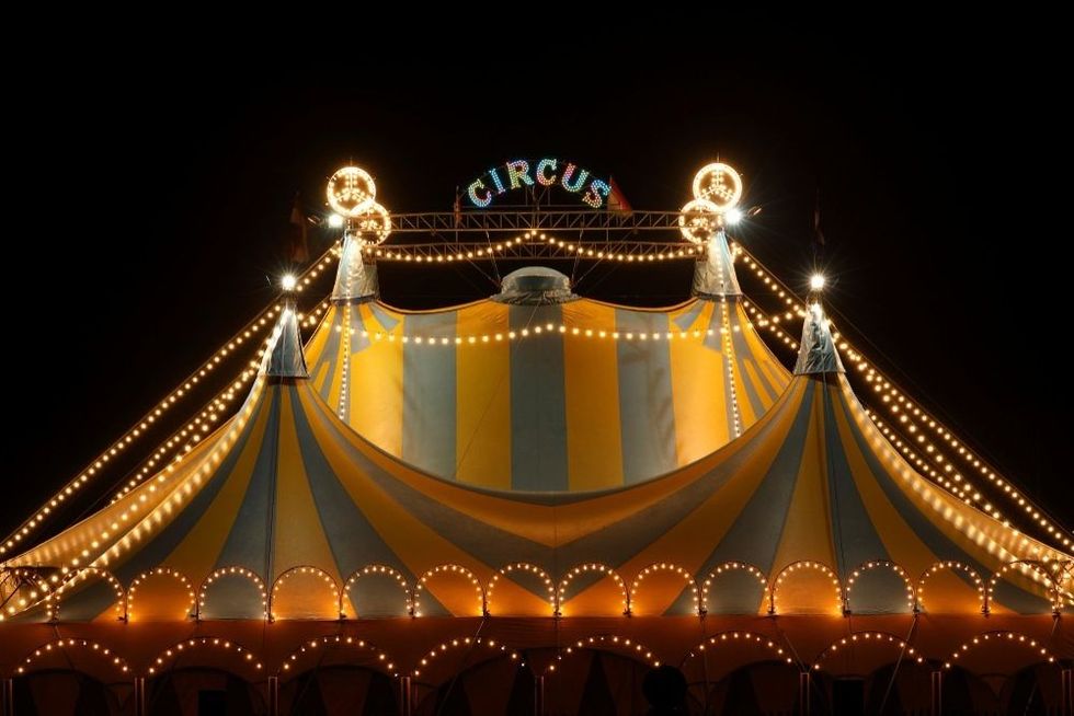 Circus tent at night with its colorful lights on