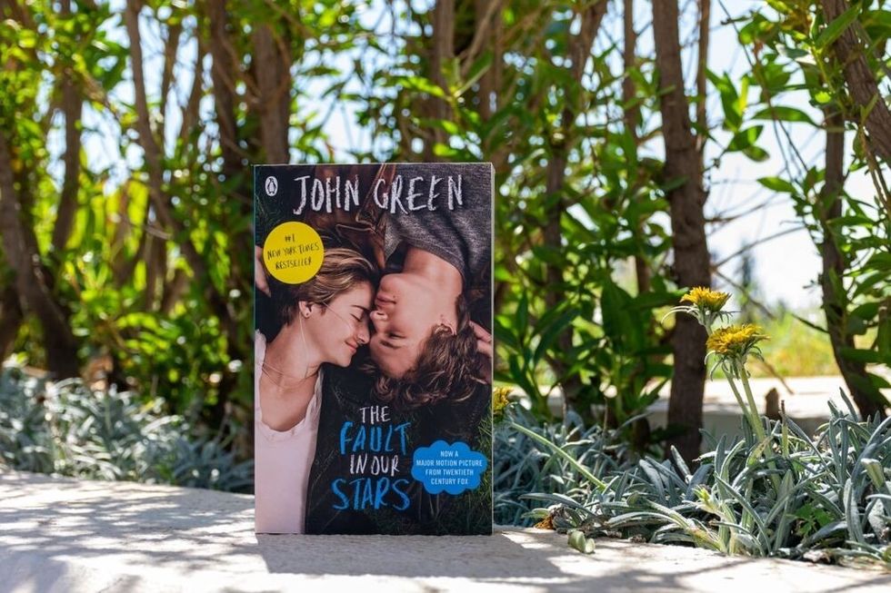Close up John Green's The Fault in Our Stars novel in the garden.