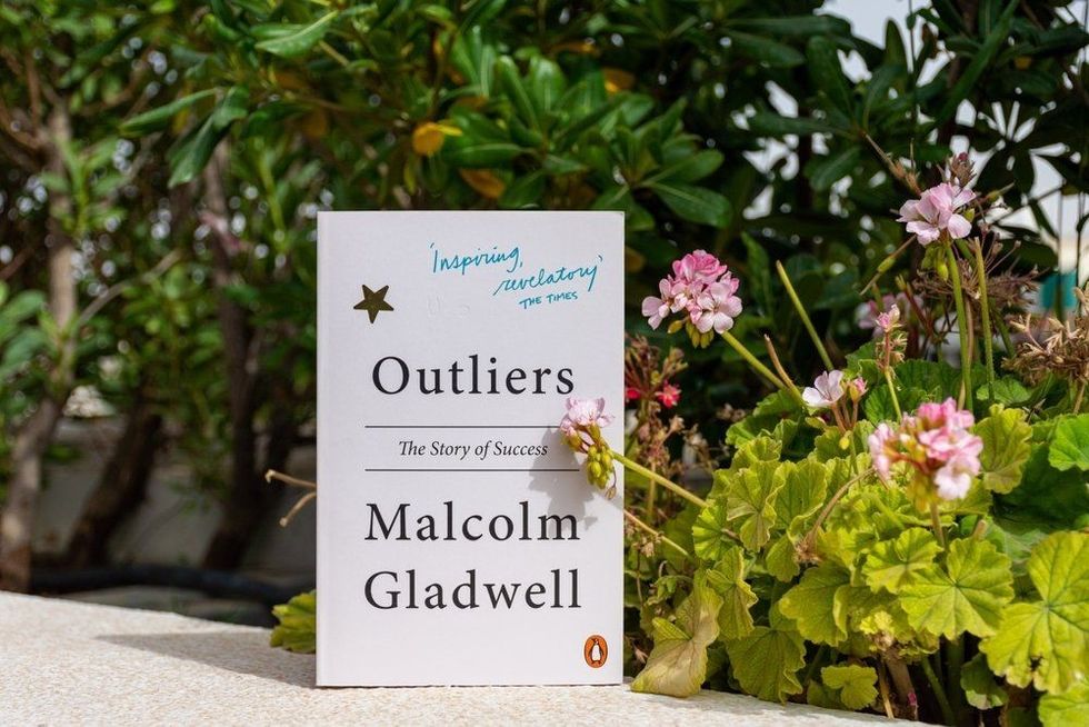 Close up Malcolm Gladwell's Outliers: The Story of Success book in the garden.