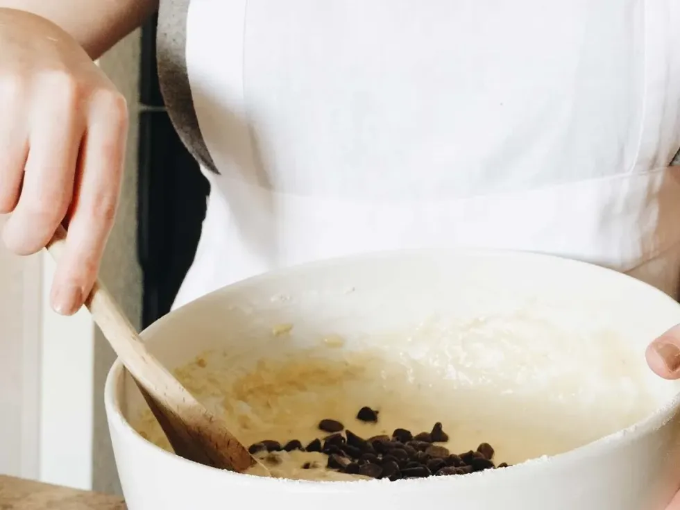Close up of person mixing the Scooby Doo cake batter with chocolate chips.