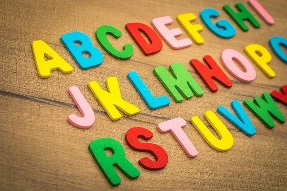 colorful alphabets arranged on wood