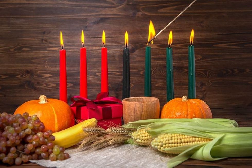 Colorful candles placed in row with wooden background.