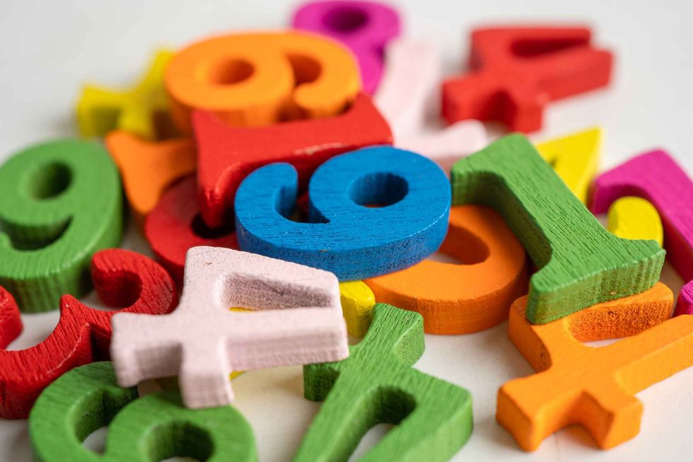 Colorful numbers made out of wooden blocks scattered