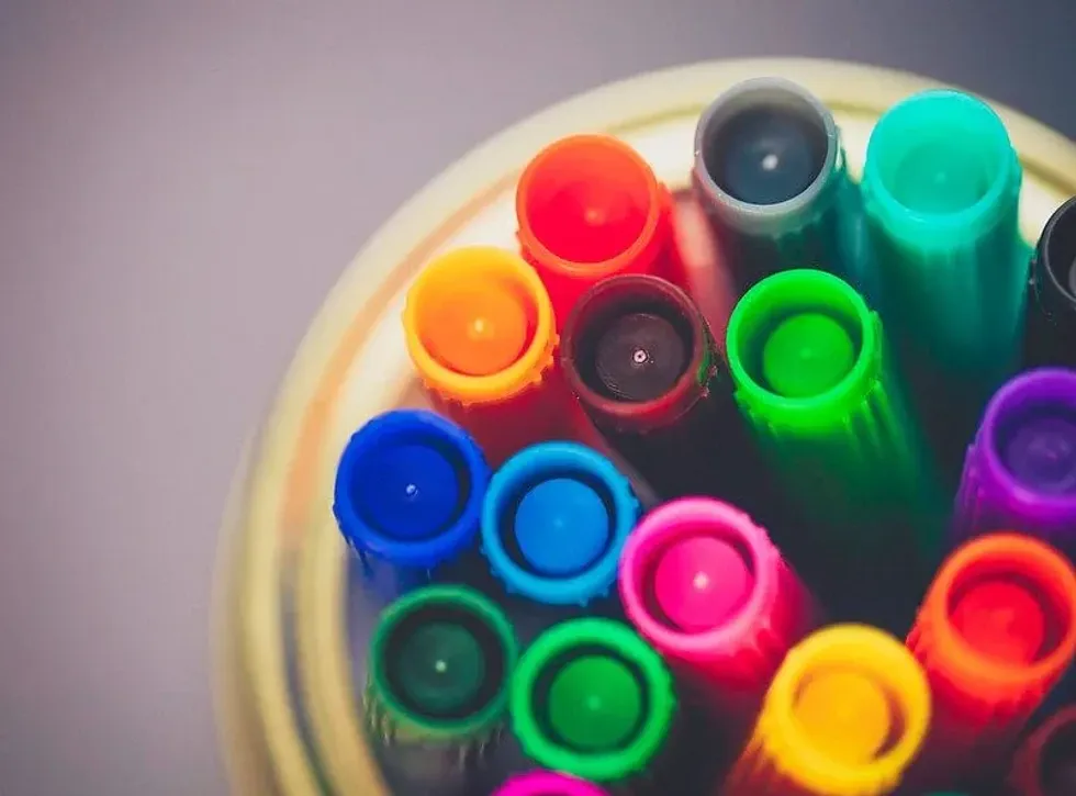 Coloured markers for colouring pages.