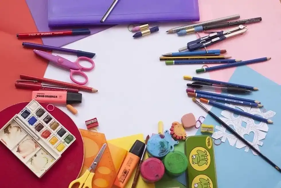 Colourful arts and crafts supplies laid out in a ring on the table.