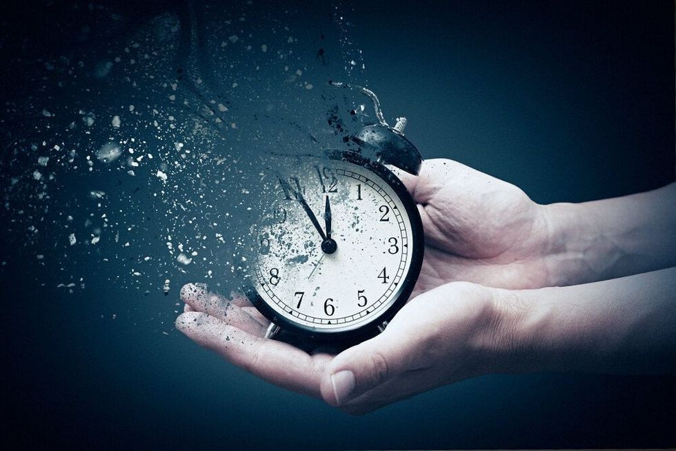 Concept of passing away, the clock breaks down into pieces.