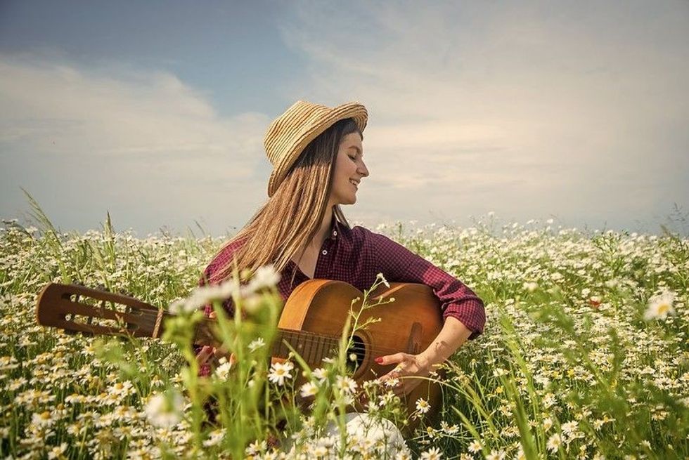Country Music Artist playing bass in the feild