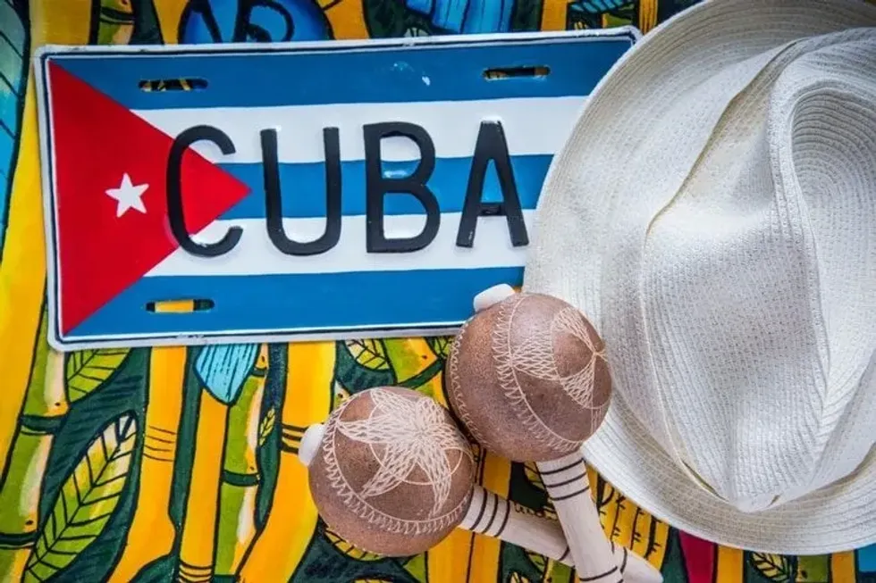 Cuban flag with Panama hat and macaras