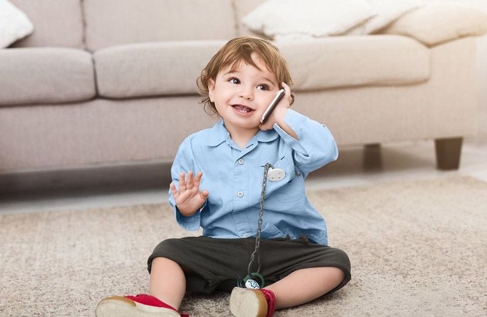 Cute baby boy blabbing with imaginary friend