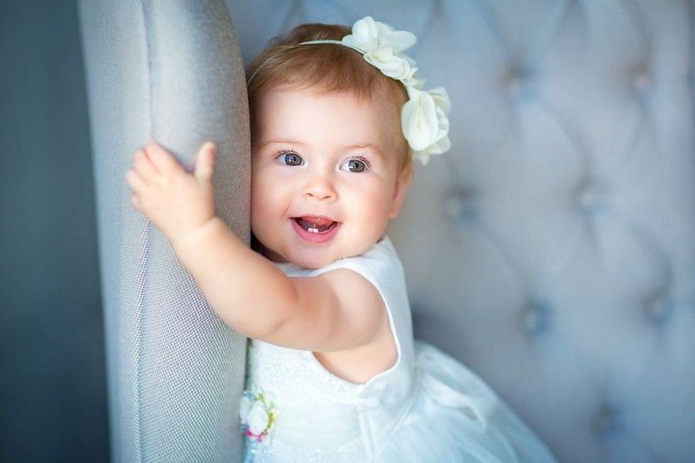 Cute baby girl in blue dress
