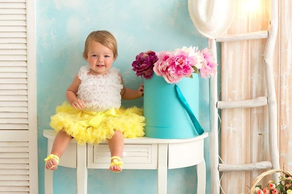 Cute baby girl wearing yellow tulle dress