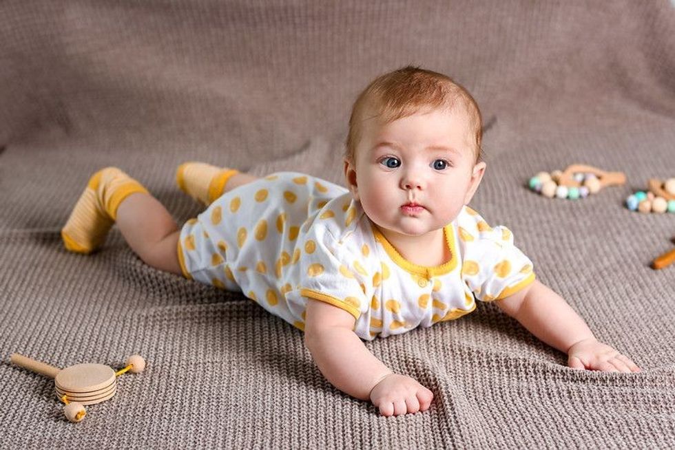 Cute baby in stylish clothes lying on bed - Nicknames