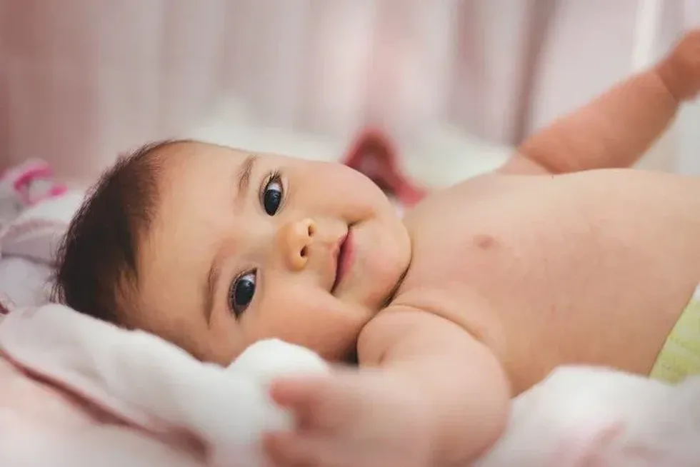 Cute baby smiling at the camera.