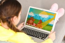 Cute girl watching cartoons at home.