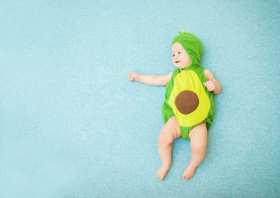 Cute smiling baby in an avocado suit