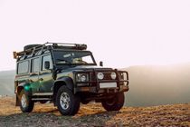 Dark green off-road car in the mountains