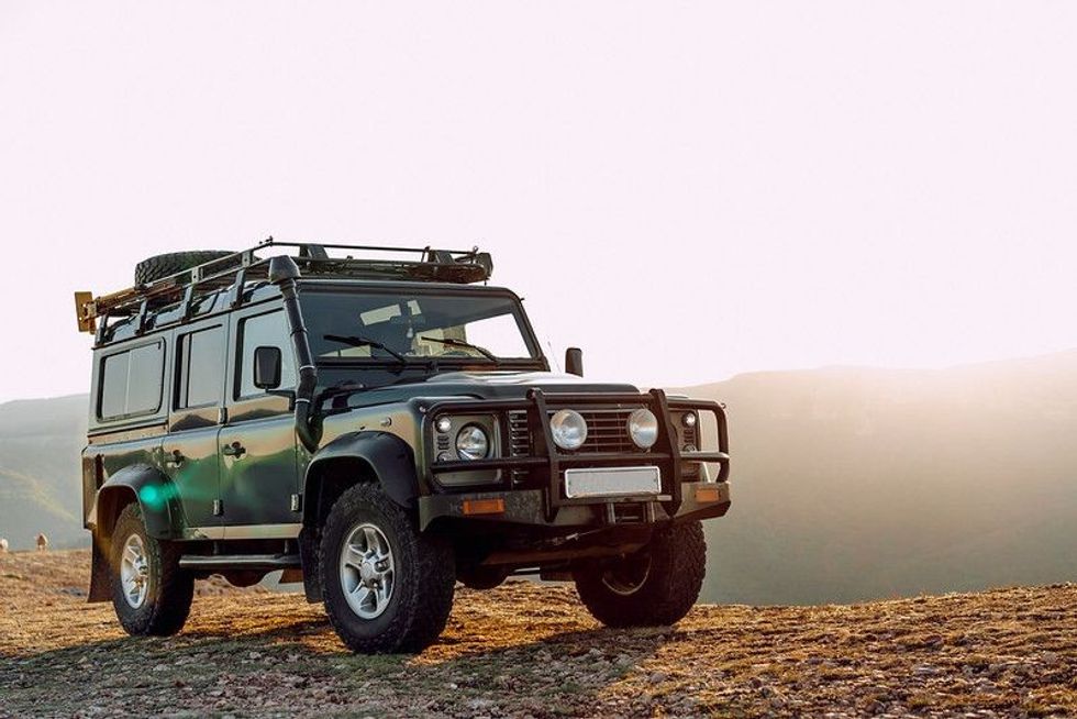 Dark green off-road car in the mountains.