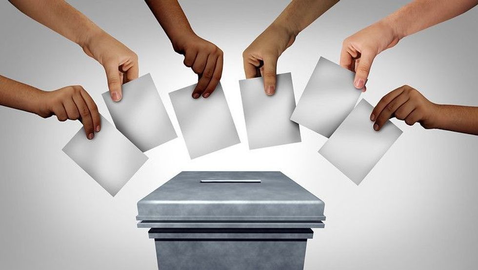 diverse hands casting ballots at a polling station in a democracy