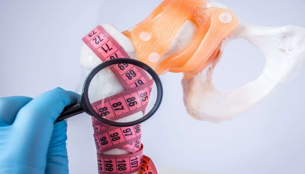 Doctor examines through magnifying.