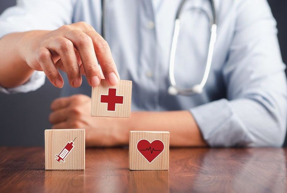 Doctor holding wooden dice icons.