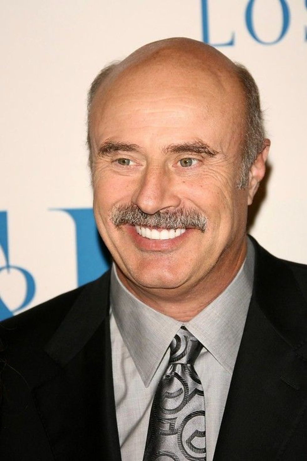 Dr. Phil McGraw wearing black suit
