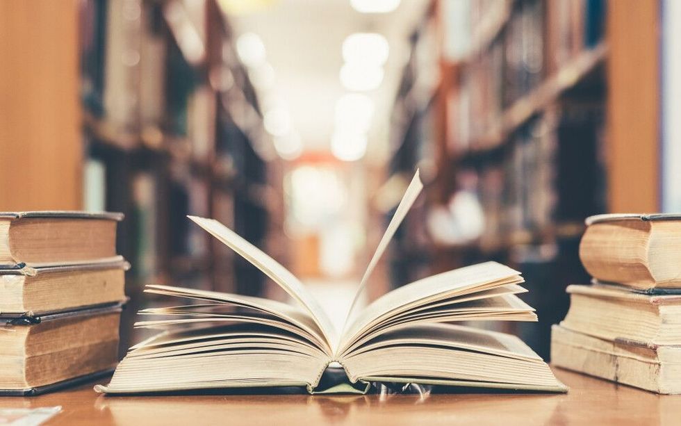 Education learning concept with opening book or textbook in old library