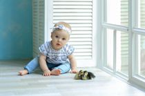 Ellie baby with blue eyes sitting at the window in a nice suit - Nicknames