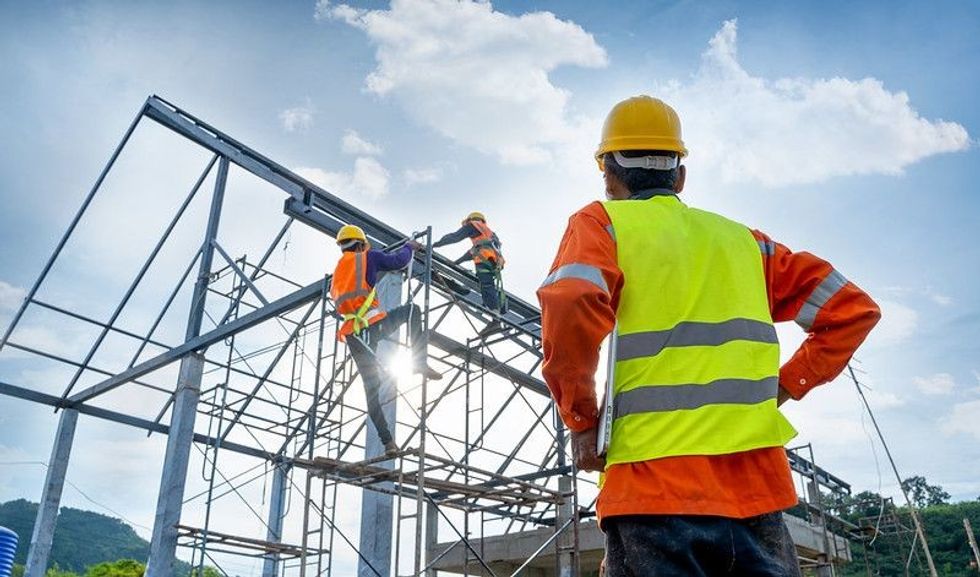 Engineer technician watching team of workers