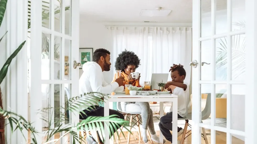 Family of three are eating on their dining table 