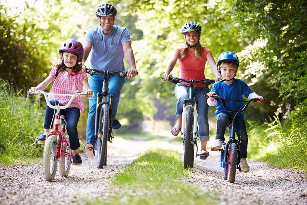 Family On Cycle Ride In Countryside.