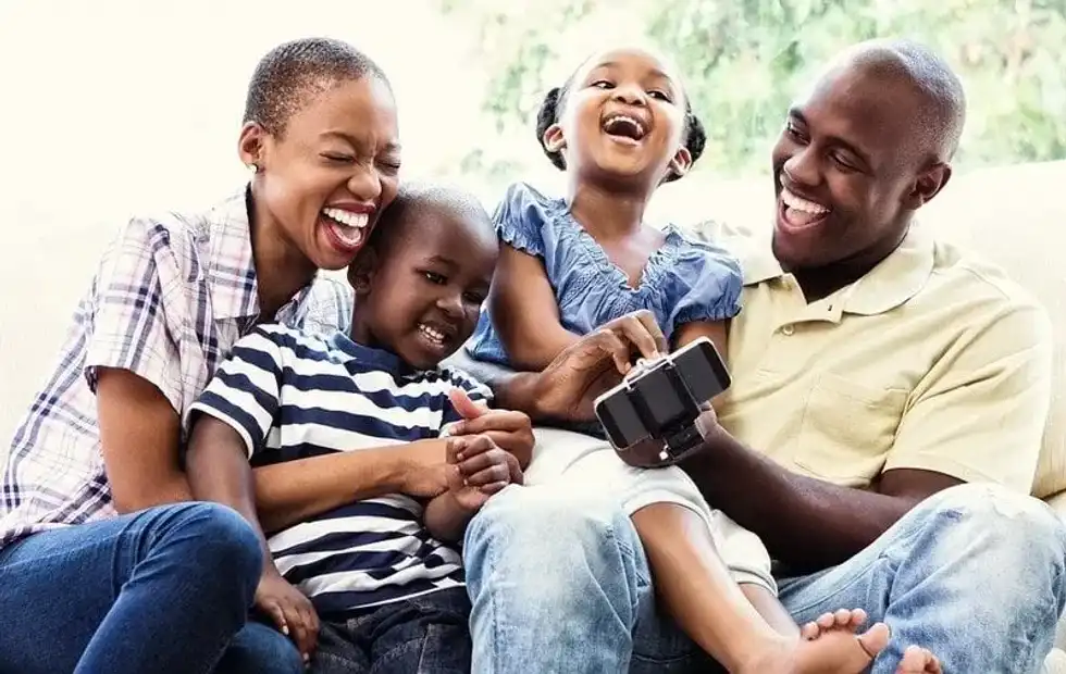 Family sat together laughing at Spiderman jokes.