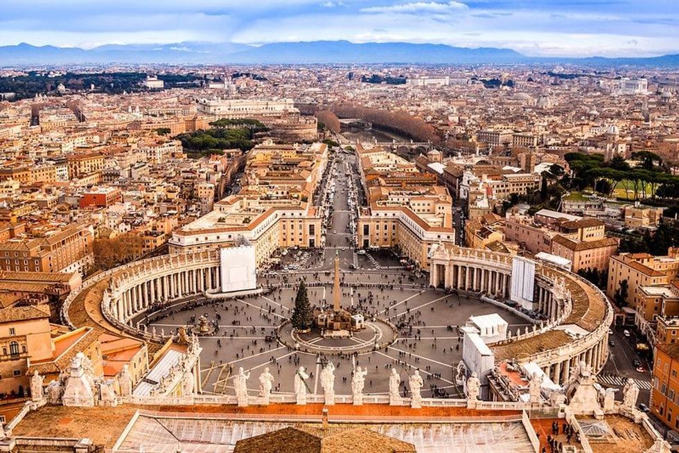 Famous Saint Peter's Square in Vatican and aerial view of the city.