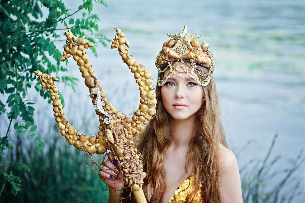 Fantasy woman real mermaid with trident myth goddess of sea with golden tail