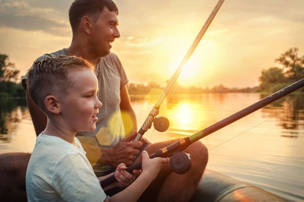 Father and son fishing in a boat