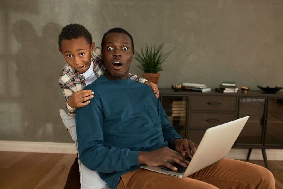 Father and son looking at camera with shock and awkward face