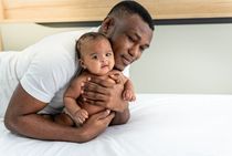 Father holding his cute little baby boy.