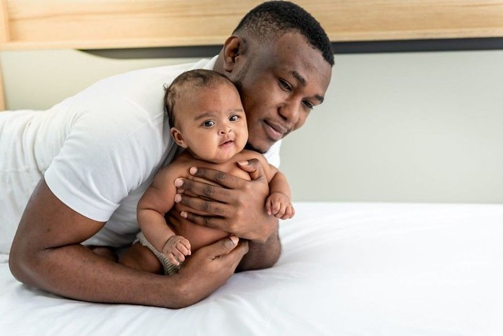 Father holding his cute little baby boy.