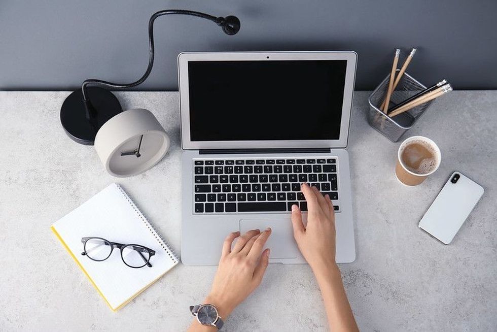 Female blogger using laptop at table