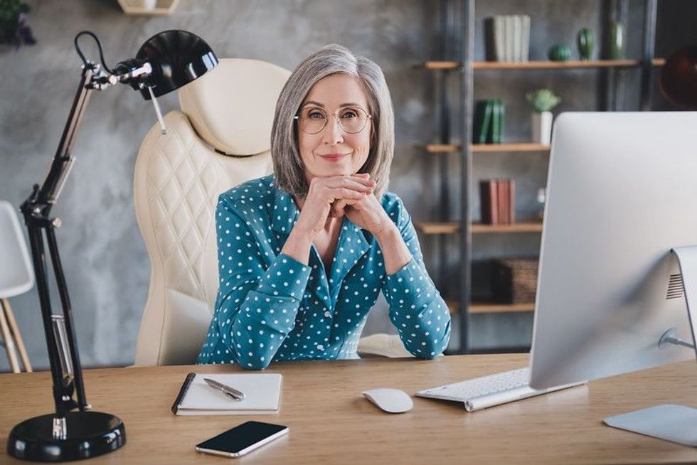 Female boss sitting in her office cabin